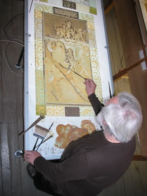 Pierre Carron painting on glass at the light table.