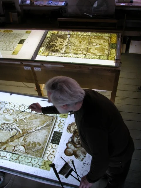 Pierre Carron in the workshop, in front of panels in progress.